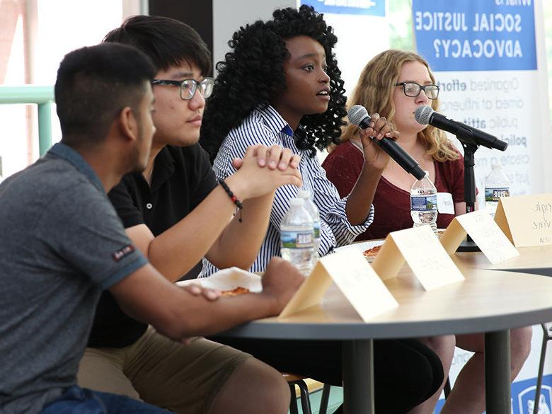 Students speaking on a panel